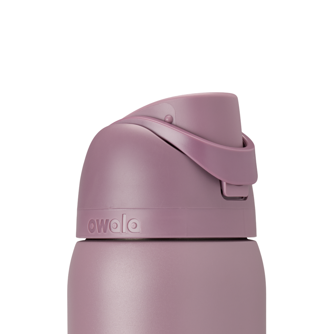 Owala FreeSip 32oz Spring Revival, lid closed detail showing dusty mauve flip cap with carry loop folded flat across the lid, accent band visible